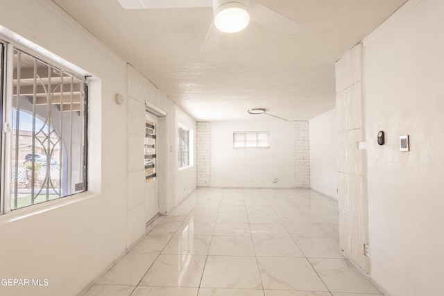 corridor with marble finish floor
