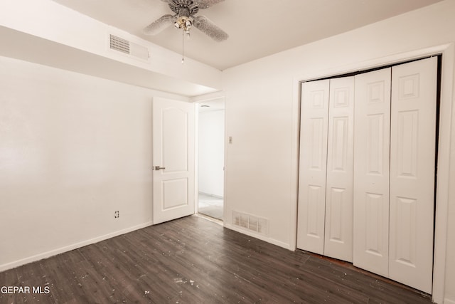 unfurnished bedroom featuring baseboards, visible vents, and dark wood-style floors