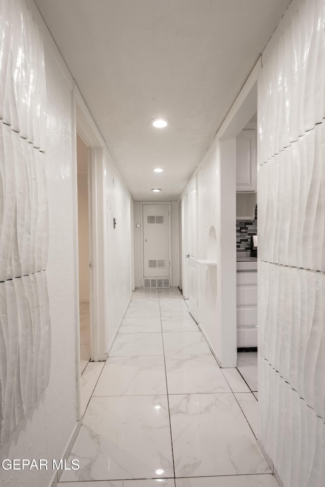 corridor featuring recessed lighting, marble finish floor, and visible vents
