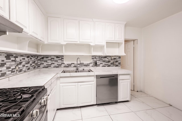 kitchen featuring open shelves, white cabinets, tasteful backsplash, a sink, and stainless steel appliances