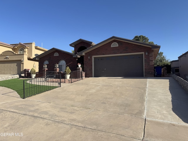 view of front of home with concrete driveway, brick siding, and an attached garage