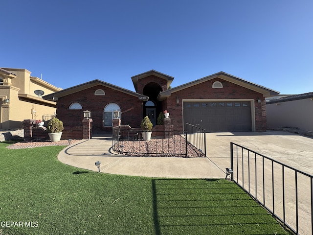 view of front of property with driveway, a garage, brick siding, and a front lawn