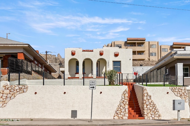 view of front of home with fence and stucco siding