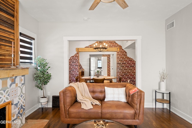 living room with visible vents, baseboards, ceiling fan, and wood finished floors