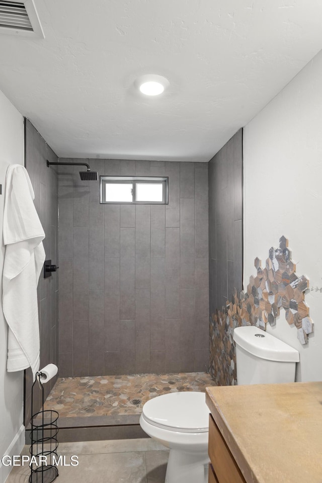 full bath with a stall shower, toilet, and visible vents