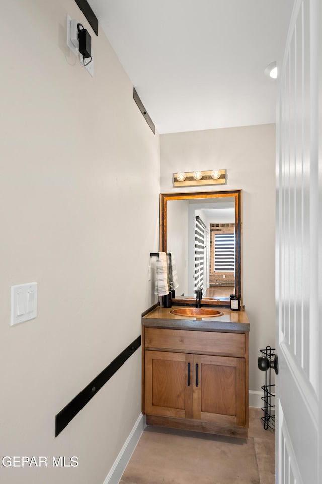 bathroom featuring baseboards and vanity
