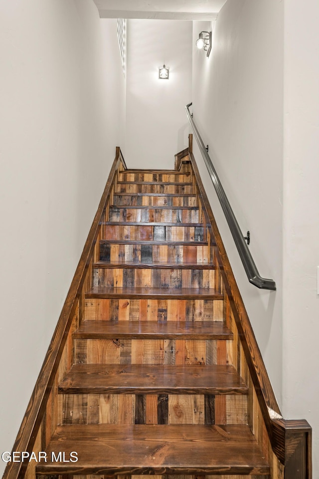 stairs featuring a towering ceiling