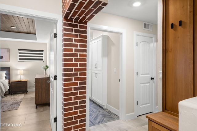 interior space with baseboards, visible vents, and light tile patterned floors