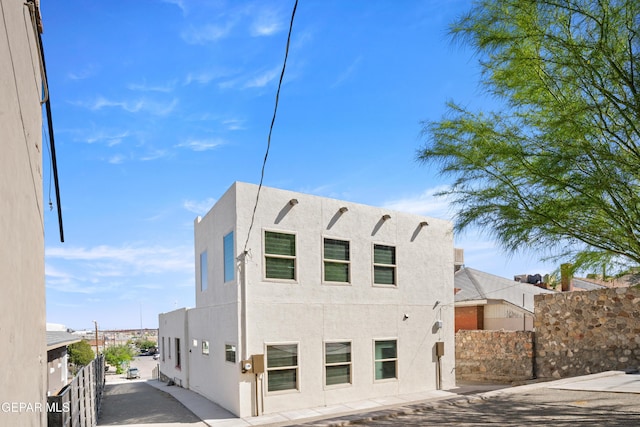 exterior space with fence and stucco siding