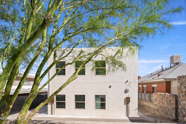 exterior space featuring central air condition unit, a patio, fence, and stucco siding