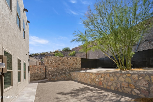 view of patio / terrace featuring fence