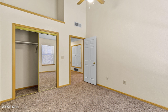 unfurnished bedroom featuring baseboards, carpet flooring, a closet, and visible vents
