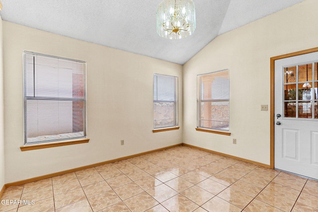 unfurnished room with lofted ceiling, a notable chandelier, baseboards, and light tile patterned floors