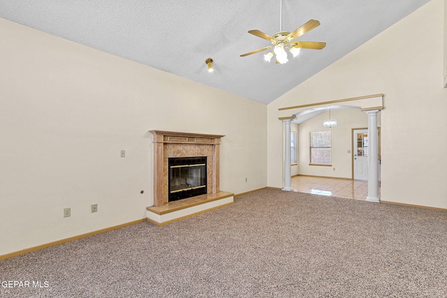 unfurnished living room featuring carpet, ceiling fan, high vaulted ceiling, and decorative columns