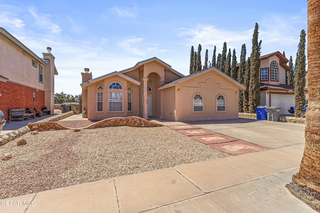 mediterranean / spanish house with stucco siding and driveway