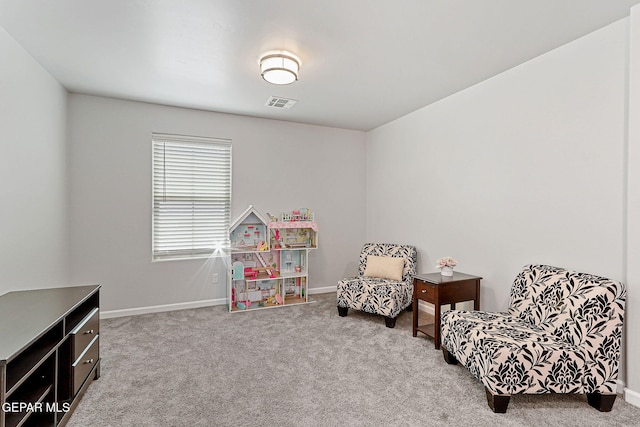 living area featuring carpet floors, baseboards, and visible vents