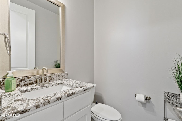 bathroom featuring toilet and vanity