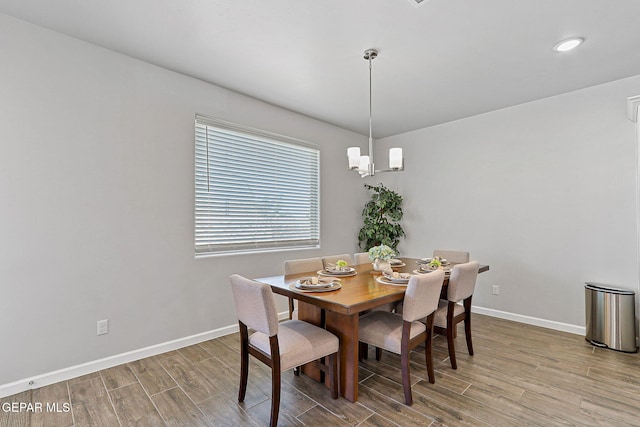 dining space with baseboards and wood finished floors