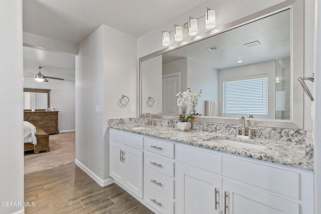 full bath featuring visible vents, a sink, a ceiling fan, and wood finished floors