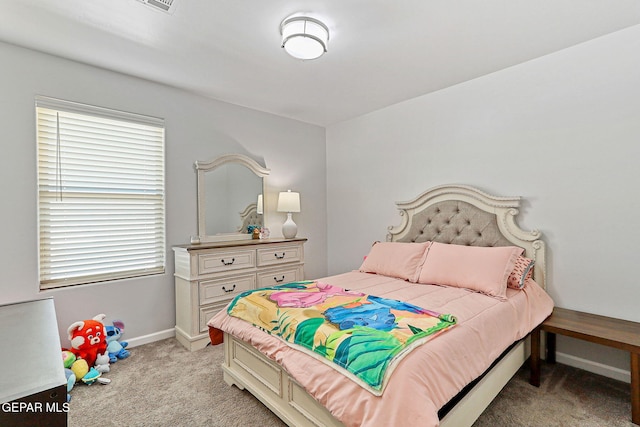bedroom featuring baseboards and light carpet