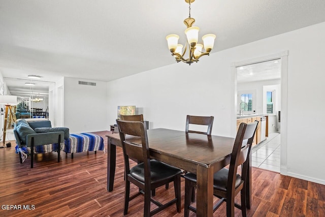 dining space featuring a chandelier and wood finished floors