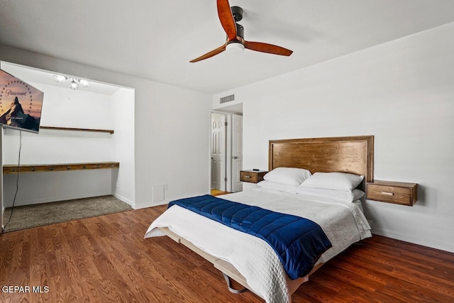 bedroom featuring wood finished floors, baseboards, and ceiling fan