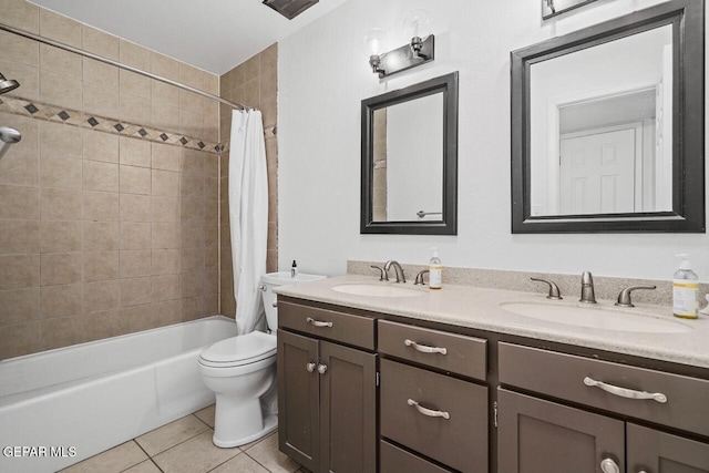 bathroom featuring tile patterned floors, shower / bath combo with shower curtain, double vanity, and toilet