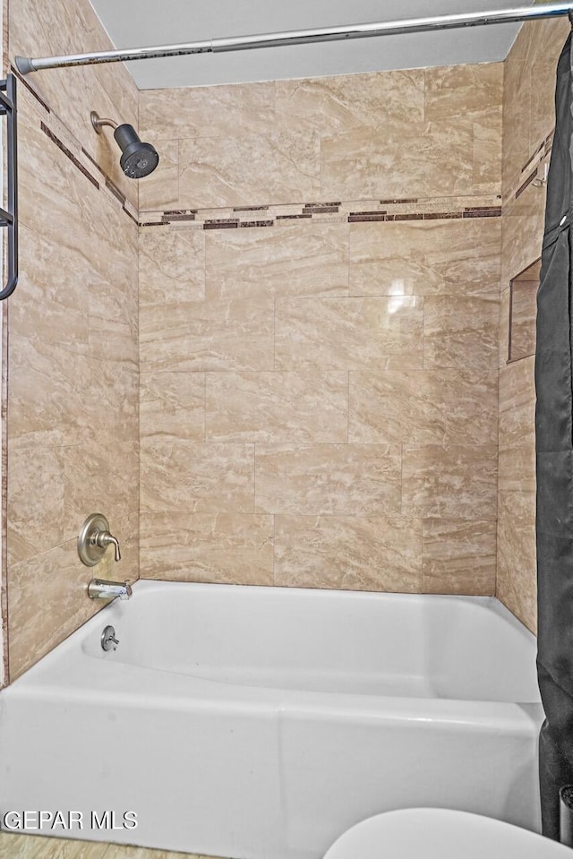 bathroom with shower / bathtub combination with curtain