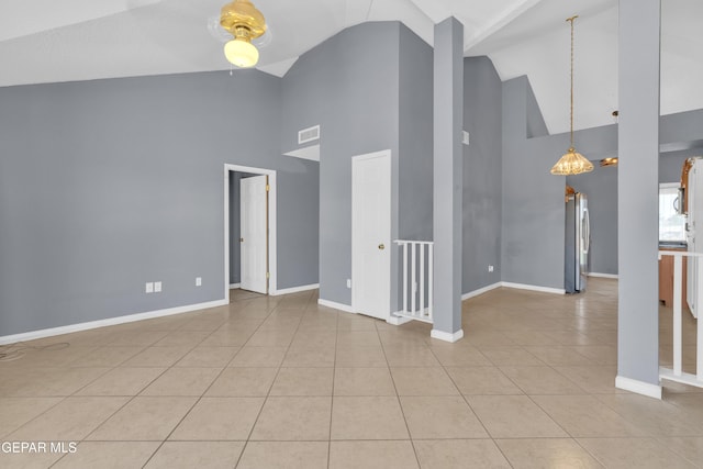 empty room featuring high vaulted ceiling, tile patterned flooring, baseboards, and visible vents