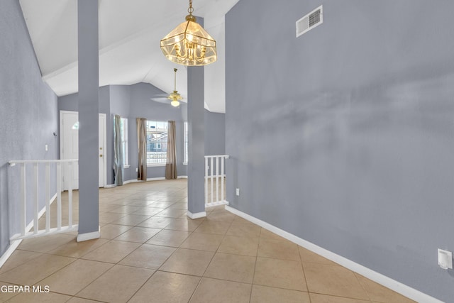 interior space with visible vents, tile patterned flooring, baseboards, high vaulted ceiling, and ceiling fan with notable chandelier