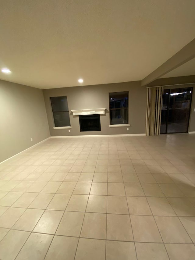 unfurnished living room with a fireplace, recessed lighting, and light tile patterned flooring