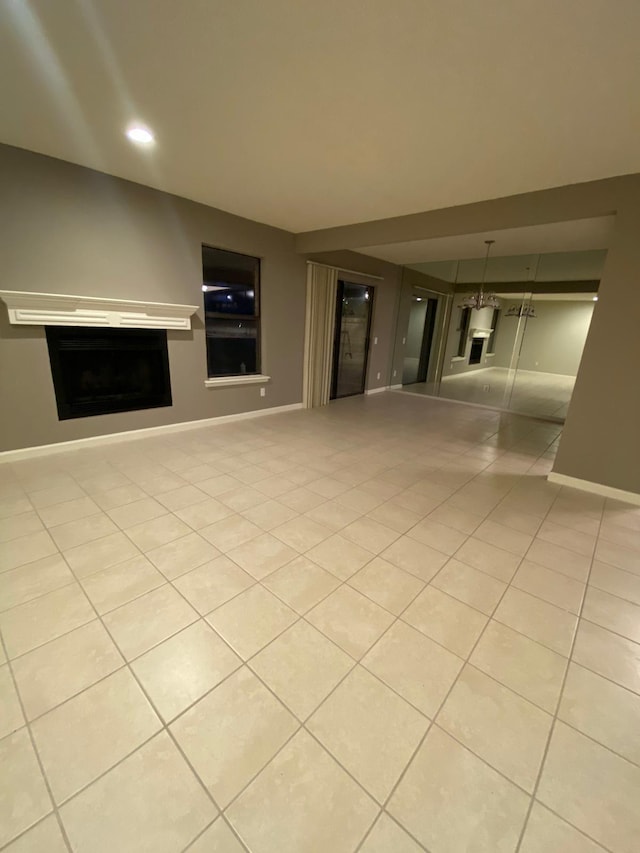 unfurnished living room with recessed lighting, baseboards, light tile patterned floors, and a fireplace