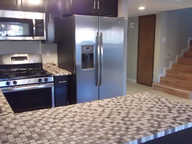 kitchen with light countertops, stainless steel appliances, and recessed lighting