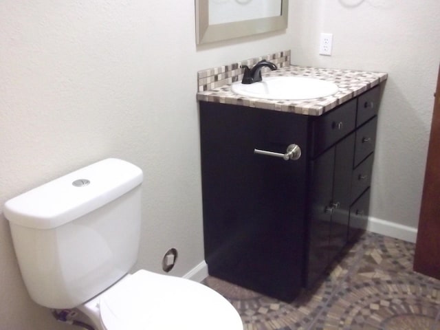 bathroom featuring toilet and vanity