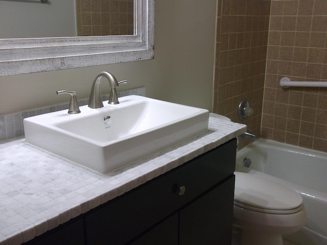 full bathroom featuring vanity, toilet, and shower / washtub combination