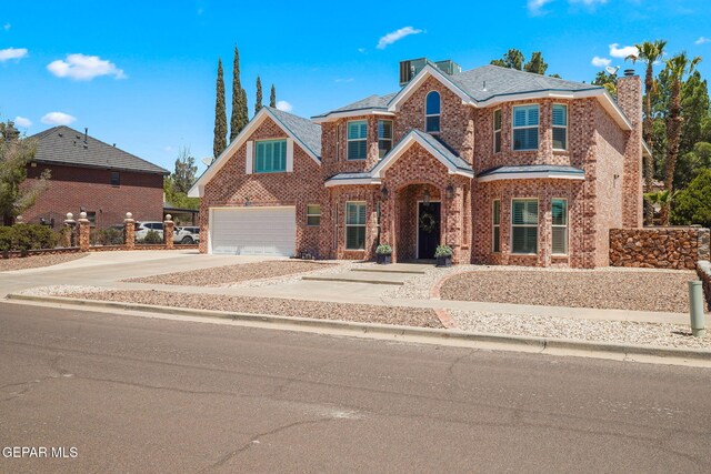 1829 Paseo Real Cir, El Paso, TX 79936 - traditional-style home with brick siding, a chimney, and concrete driveway