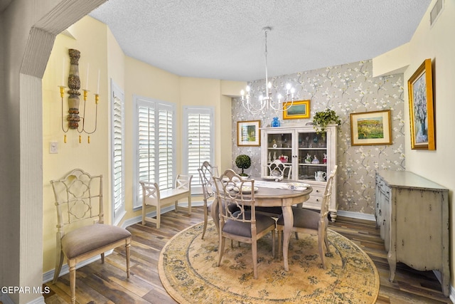 1829 Paseo Real Cir, El Paso, TX 79936 - dining space with an inviting chandelier, a textured ceiling, wallpapered walls, baseboards, and visible vents