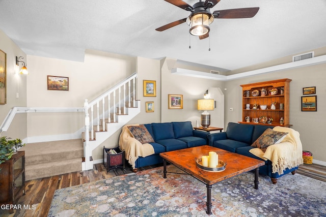 1829 Paseo Real Cir, El Paso, TX 79936 - living room with ceiling fan, visible vents, wood finished floors, baseboards, and stairs