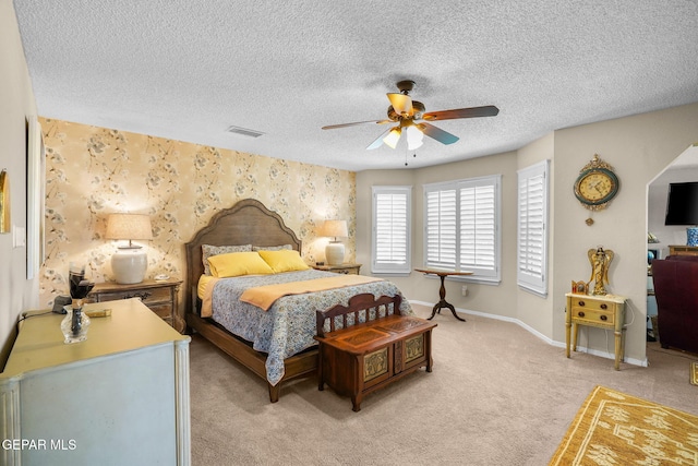 1829 Paseo Real Cir, El Paso, TX 79936 - bedroom featuring visible vents, an accent wall, baseboards, light colored carpet, and a textured ceiling