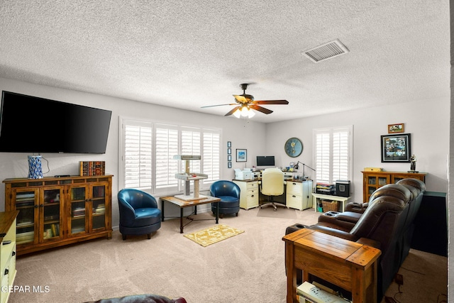 1829 Paseo Real Cir, El Paso, TX 79936 - living room featuring carpet floors, a ceiling fan, a textured ceiling, and visible vents