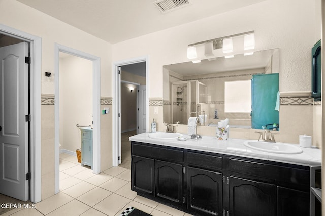 1829 Paseo Real Cir, El Paso, TX 79936 - bathroom with visible vents, a sink, tile patterned flooring, and double vanity