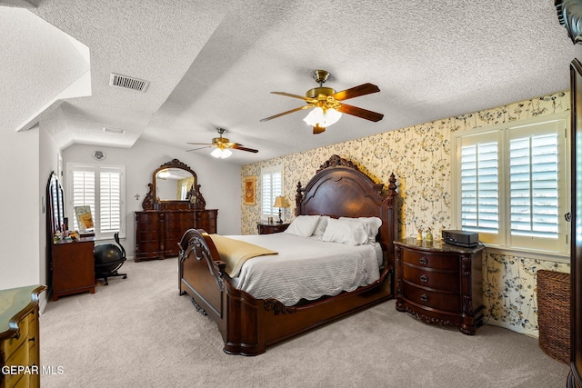 1829 Paseo Real Cir, El Paso, TX 79936 - carpeted bedroom with multiple windows, wallpapered walls, a textured ceiling, and visible vents