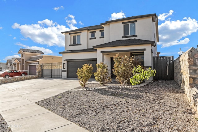 view of front of property featuring an attached garage, stucco siding, fence, and concrete driveway