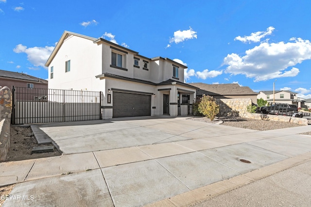 traditional-style home with a garage, fence, stucco siding, a gate, and driveway