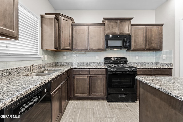 kitchen with a sink, backsplash, black appliances, and dark brown cabinetry
