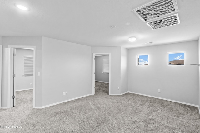 below grade area featuring carpet floors, baseboards, and visible vents