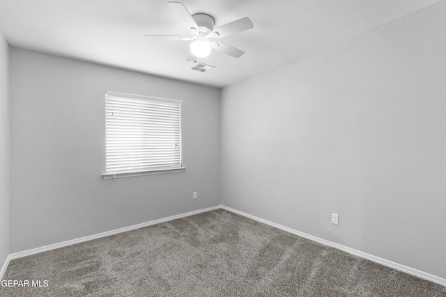 spare room with baseboards, carpet, a ceiling fan, and visible vents