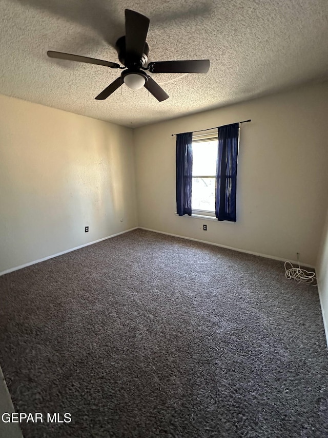 carpeted empty room featuring baseboards, a ceiling fan, and a textured ceiling