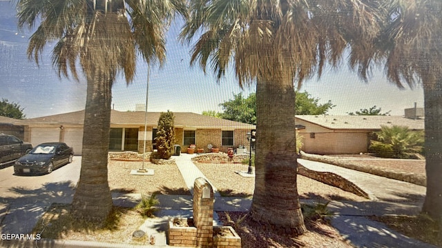 view of front of property featuring a garage and concrete driveway