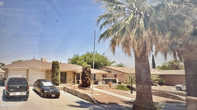 single story home with an attached garage and driveway